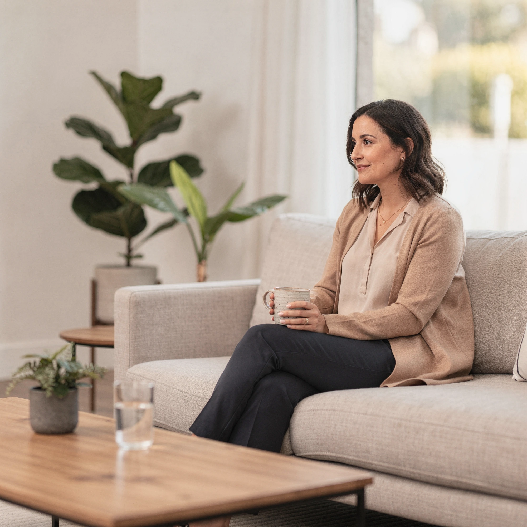 Psychiatrist in Chatsworth, CA – client talking with a therapist in a bright office at Uriel Behavioral Wellness